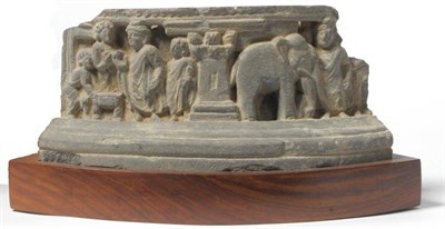 Lot 214 - A Gandhara Schist Elliptical Frieze, 2nd-4th century AD, depicting a column flanked by various...