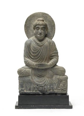 Lot 218 - A Gandhara Schist Figure of Buddha, 3rd century style, the seated figure with circular halo on...