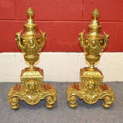 Lot 242 - A Pair of Brass Andirons, in late 17th century style, the urn finials with mask handles hung...
