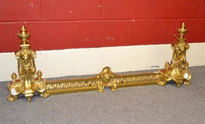 Lot 243 - A Brass Fender, in Regency style, of pierced form centred by a lion's mask flanked by scroll...