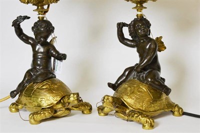Lot 277 - A Pair of Parcel Gilt Bronze Candlesticks, 19th century, the scroll and grape cast sconces...