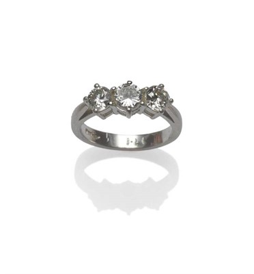 Lot 380 - A Platinum Diamond Three Stone Ring, the round brilliant cut diamonds in claw settings to a tapered