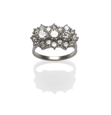 Lot 382 - A Diamond Triple Cluster Ring, the round brilliant cut stones held in white claw settings to a...