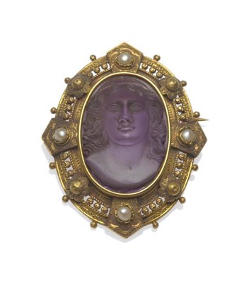 Lot 392 - A Victorian Cameo Portrait Brooch, a central amethyst carved to depict a maiden, within a...