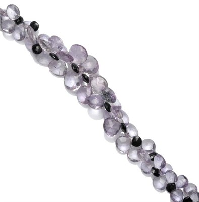 Lot 395 - An Amethyst and Onyx Necklace, strung with graduated faceted drops, to a grooved spherical...