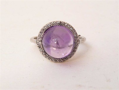 Lot 401 - An Amethyst and Diamond Ring, a round cabochon amethyst within a border of rose cut diamonds,...