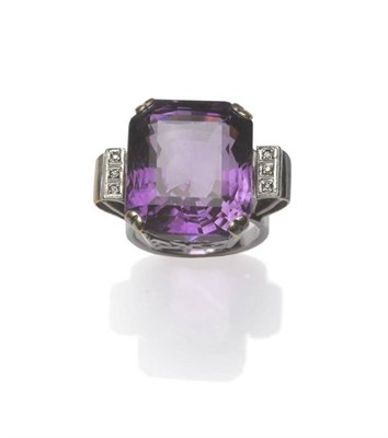 Lot 409 - An Amethyst and Diamond Ring, the oblong mixed cut amethyst with truncated corners, in white corner