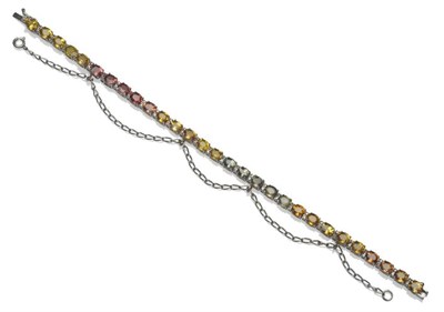 Lot 411 - A Multi-Coloured Sapphire and Diamond Bracelet, the oval cut sapphires run in colour sequence...