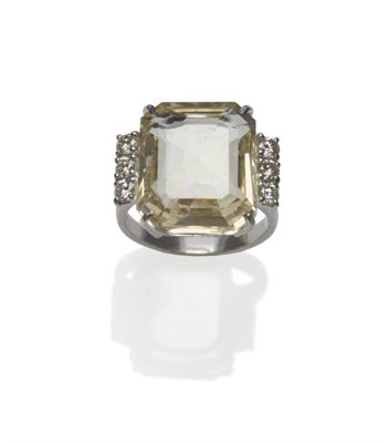 Lot 414 - An 18 Carat White Gold Yellow Scapolite and Diamond Ring, the oblong scapolite with truncated...