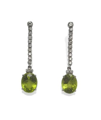 Lot 415 - A Pair of 18 Carat White Gold Diamond and Peridot Drop Earrings, a string of round brilliant...