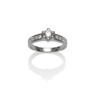 Lot 419 - A Diamond Solitaire Ring, the round brilliant cut diamond in a white six claw setting above...