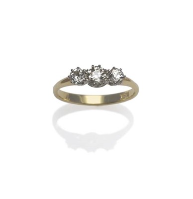 Lot 428 - A Diamond Three Stone Ring, the graduated old cut diamonds in white claw settings on a yellow...