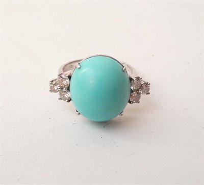 Lot 433 - A 14 Carat Gold Turquoise and Diamond Ring, an oval cabochon turquoise between a trio of round...