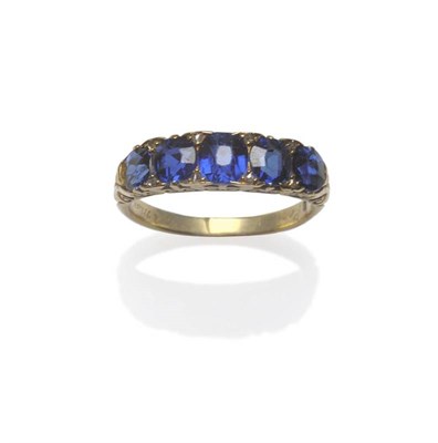 Lot 441 - A Late Victorian Sapphire and Diamond Ring, the five graduated cushion shaped sapphires in...