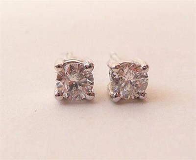 Lot 461 - A Pair of Diamond Solitaire Stud Earrings, the round brilliant cut diamonds in white four claw...