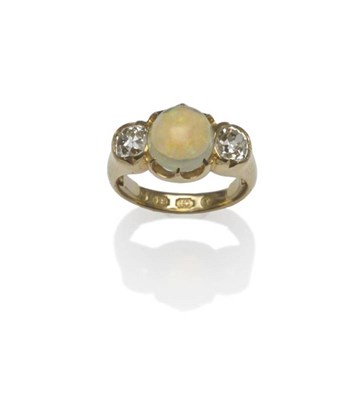 Lot 462 - A Victorian 18 Carat Gold Opal and Diamond Three Stone Ring, the oval cabochon opal flanked by...