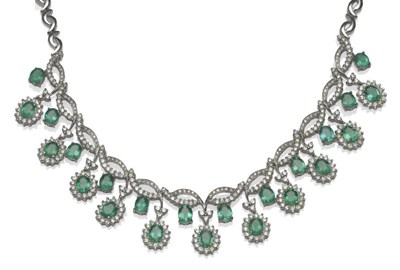 Lot 464 - An Emerald and Diamond Necklace, eleven clusters of oval cut emeralds within round brilliant...