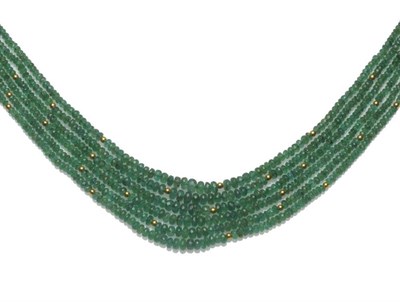 Lot 466 - An Emerald Six Strand Necklace, the graduated faceted beads spaced at intervals by gold...