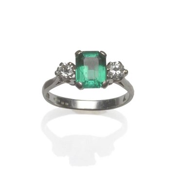 Lot 468 - A Synthetic Emerald and Diamond Three Stone Ring, the emerald-cut emerald flanked by a round...