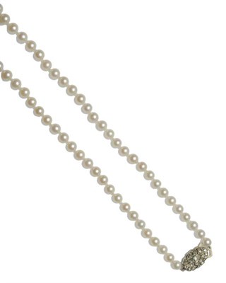 Lot 473 - A Cultured Pearl Necklace, sixty-three graduated pearls knotted to an Art Deco diamond set...