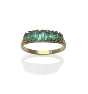 Lot 474 - A Late Victorian 18 Carat Gold Emerald and Diamond Ring, the five graduated step cut emeralds...