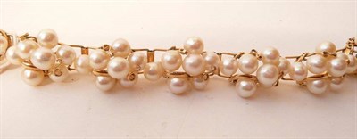 Lot 477 - A Cultured Pearl Bracelet, articulated links of clusters of slightly off-round pearls, with...