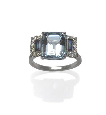 Lot 485 - An 18 Carat White Gold Aquamarine, Sapphire and Diamond Ring, the step cut aquamarine flanked...