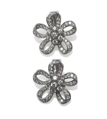 Lot 491 - A Pair of Diamond Cluster Earrings, each as a stylised flower, a cluster of round brilliant cut...