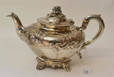 Lot 562 - A Victorian Silver Teapot, maker's mark HH, London 1859, of compressed cushion form, C scroll...