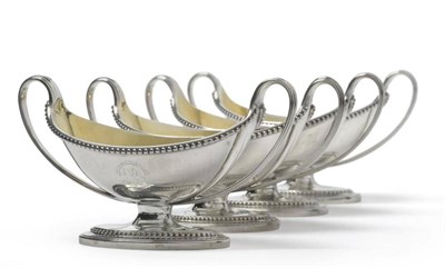 Lot 586 - A Set of Four George III Silver Salt Cellars, William Frisbee, London 1793, the beaded pedestal...