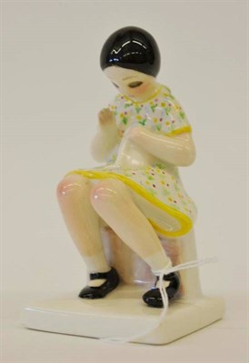 Lot 1002 - A Lenci Figure of a Child, the seated girl wearing a floral painted dress, black painted marks...