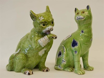 Lot 1004 - A Mosanic Faience Figure of a Cat, early 20th century, with glass eyes, the green animal...