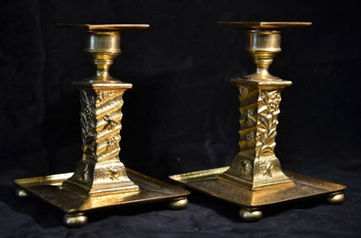 Lot 1032 - A Pair of Aesthetic Movement Gilt Metal Candlesticks, square drip tray, on a fluted column...