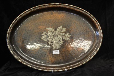 Lot 1042 - An Arts & Crafts Oval Hammered Copper and White Metal Inlaid Tray, by Hugh Wallis, the well...