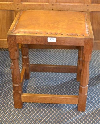 Lot 1061 - A Robert  "Mouseman " Thompson Oak Dressing Table Stool, upholstered cow hide seat, on four...