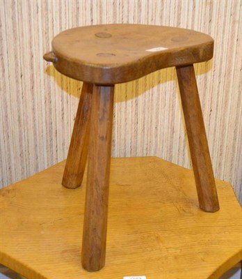 Lot 1064 - A Robert  "Mouseman " Thompson Oak Cow Stool, on three tapering octagonal legs, with carved...