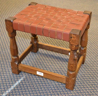 Lot 1069 - A 1930's Robert  "Mouseman " Thompson Oak Stool, with lattice leather seat, on four turned legs...