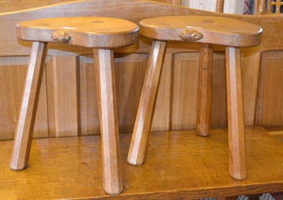 Lot 1079 - A Pair of Peter  "Rabbitman " Heap Oak Cow Stools, on three octagonal legs, each with a carved...