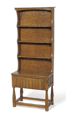 Lot 1092 - A Thomas  "Gnomeman " Whittaker Oak Dresser, the rack with three open shelves, the base fitted with