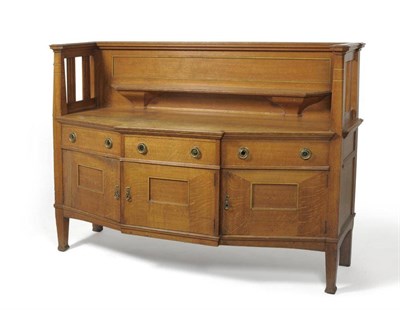 Lot 1101 - An Arts & Crafts Oak Bow Fronted Sideboard, probably retailed by Liberty & Co, the raised back with