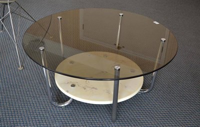 Lot 1126 - A 1960's Italian Coffee Table, the circular smoky glass top, above a faux marble undertier with...