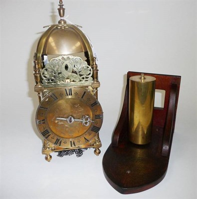 Lot 1169 - A Brass Striking Lantern Clock, 20th century, with pierced dolphin frets, top mounted bell and side