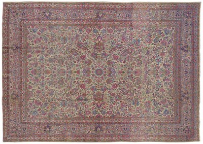 Lot 1240 - Kirman Carpet South East Persia The ivory field with an allover design of scrolling leafy vines and