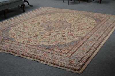 Lot 1244 - Kirman Carpet South East Persia the cream field of scrolling vines around a pale blue pole...