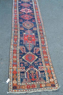 Lot 1245 - Narrow Malayir Runner West Persia The deep indigo field with a single column of latch hook...