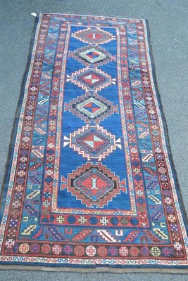 Lot 1246 - Kazak Runner Central Caucasus The indigo field with a column of stepped medallions enclosed by leaf