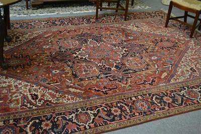 Lot 1253 - Heriz Carpet Persian Azerbaijan The terracotta lozenge field of angular vines around an indigo pole