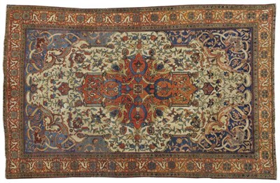 Lot 1258 - Saroukh Rug West Persia The ivory field of scrolling leafy vines around a madder medallion...