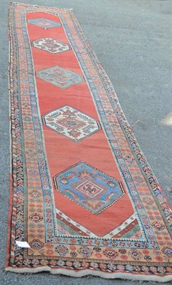 Lot 1263 - Heriz Runner Persian Azerbaijan The terracotta field with a column of six hexagons containing...