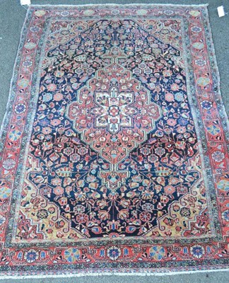 Lot 1272 - Jozan Rug West Persia The deep indigo field of floral vines around a madder pole medallion...